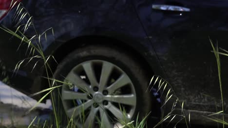 Outdoor-nature-car-driving-through-muddy-puddles-sedan