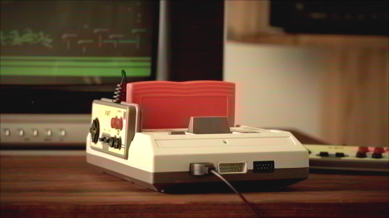 Person inserting a game cartridge into a retro Nintendo console.