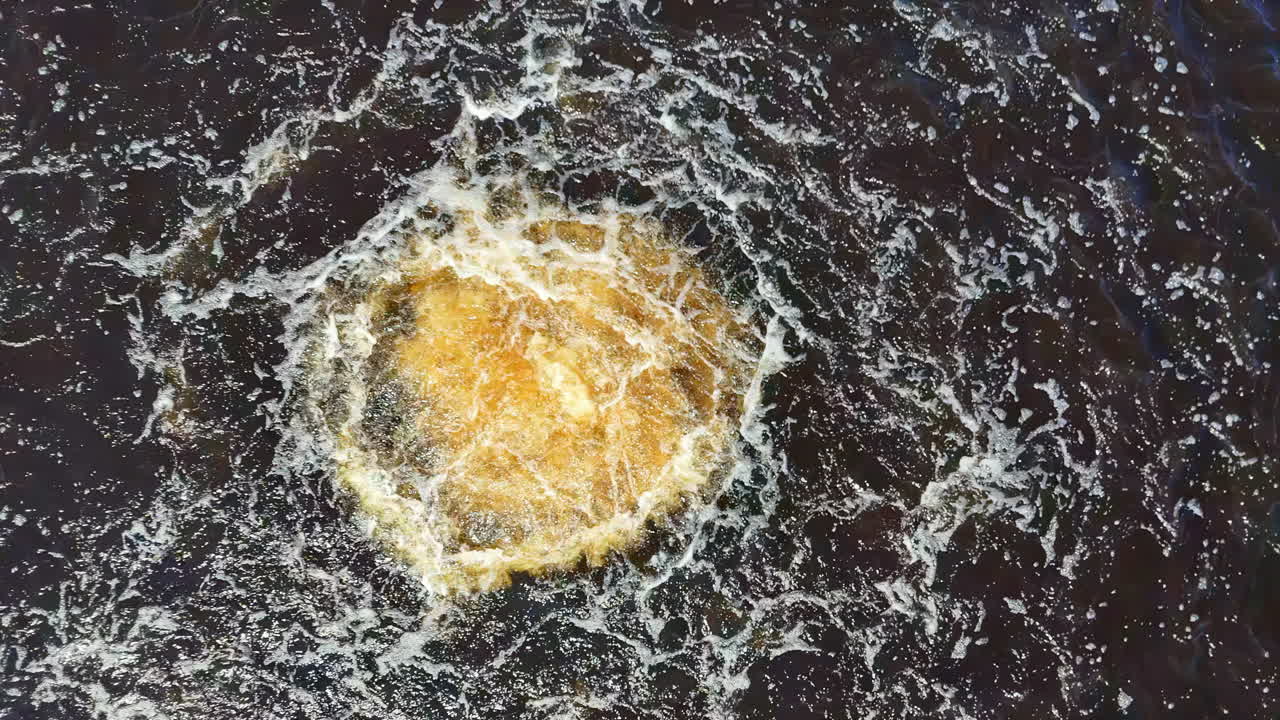 Turbulent Aerial Perspective of a Subsea Pipeline Breach, Manifesting as an Intense Vortex of Muddy Yellow Water and White Froth Against the Deep Blue Ocean, Reminiscent of the Nord Stream Blast