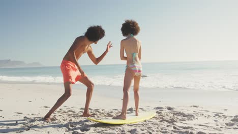 Friends-training-surf-styling-on-the-sand-