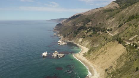 drone flies above hidden beaches on the california coast