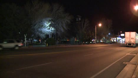 an unmarked double tractor trailer truck drives through the night