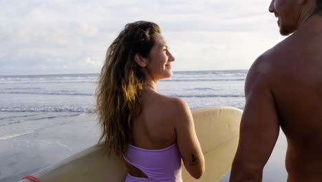 young couple with surfboards