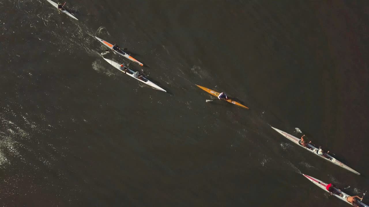 Drone footage of paddlers racing on a flat water lake