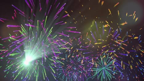 Digital-animation-of-spots-of-light-and-fireworks-exploding-against-black-background