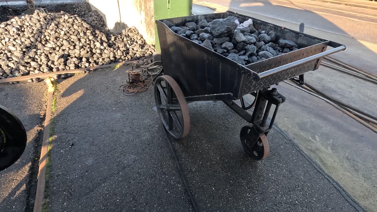 A coal tender bin that is loaded with coal, the coal is used by a steam engine locomotive.
