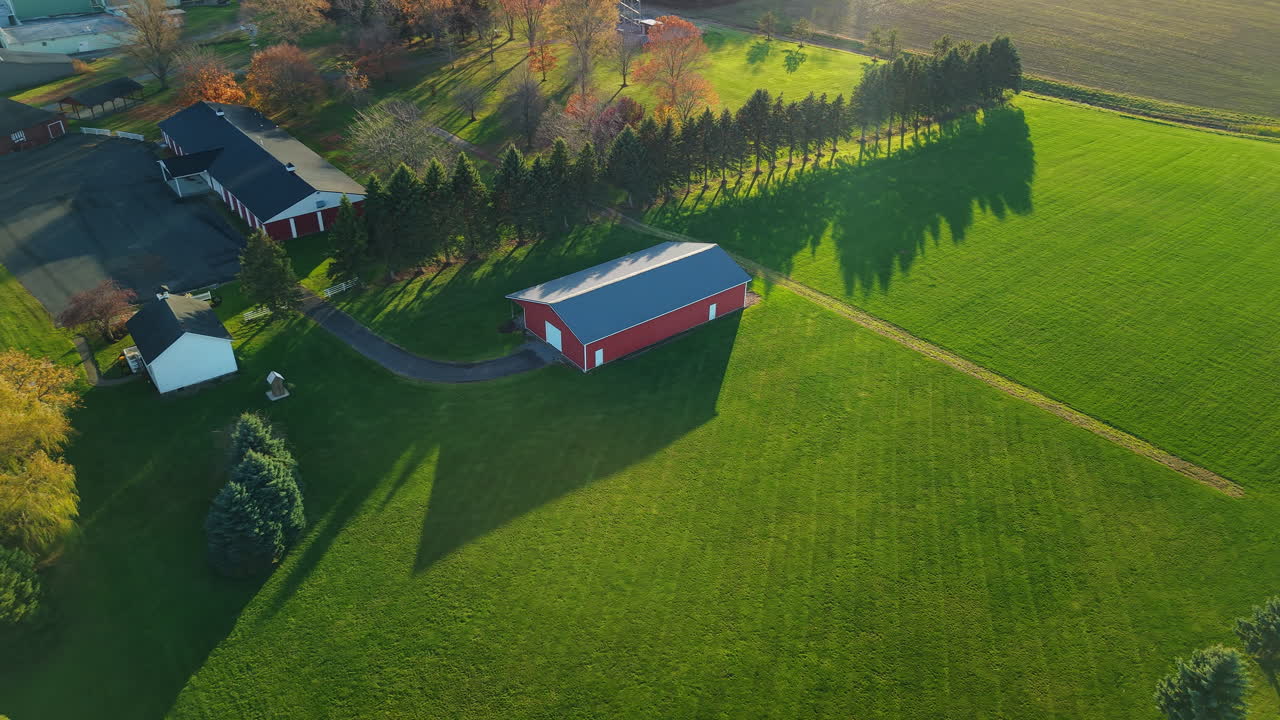 Aerial view of a red barn and surrounding landscape