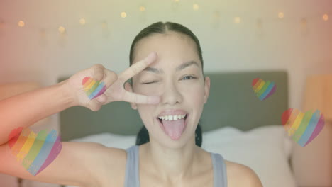 winking and sticking out tongue, person with rainbow hearts animation