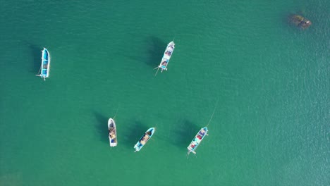 colorful fishing boats anchored in beautiful turquoise waters of acapulco, mexico