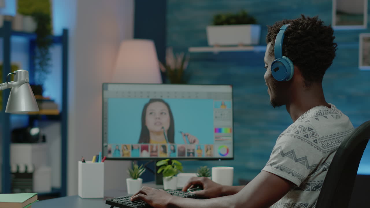 Photographer with headphones editing pictures on retouch software