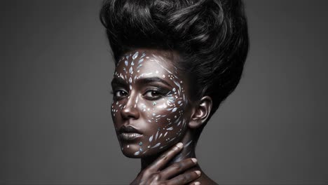 captivating portrait of a model showcasing artistic body paint and elaborate hairstyle, exuding bold style and uniqueness in high-contrast photography