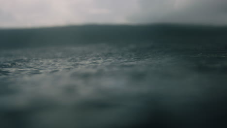 mesmerizing dreamy view of ocean water surface as rain bounces