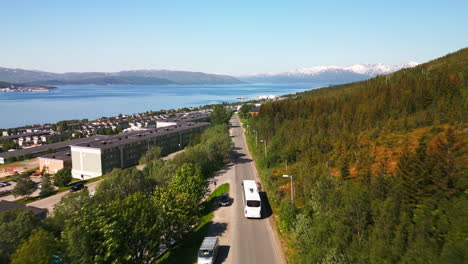 bus ride along lush green forest and urban area in tromso, norway