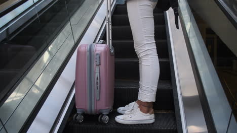 woman traveling on escalator