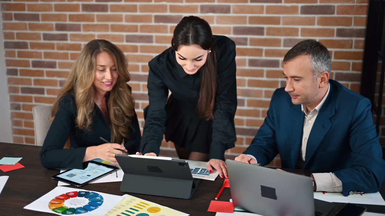 Woman making a presentation to her coworkers in an office