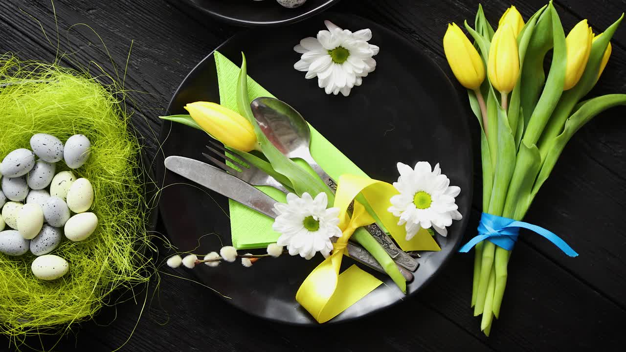 Easter spring table dishware composition with yellow tulip flower