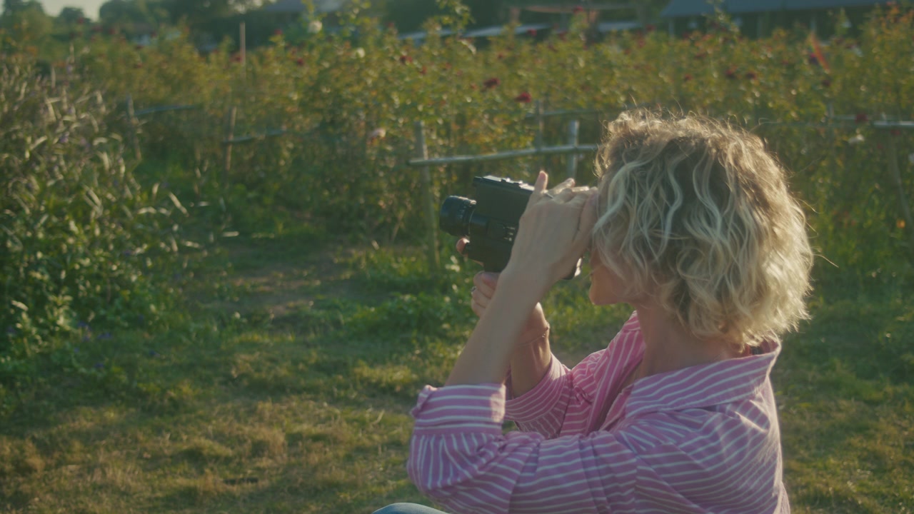 Woman Filming with Vintage Super 8 Camera in Garden