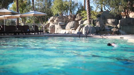 a swimmer enjoys a morning swim at the pool