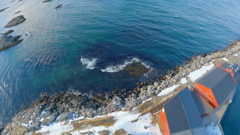 High-angel-view-from-Andenes-Lighthouse-towards-the-ocean,-waves-breaking-on-the-shoreline,-Norway