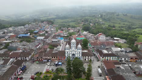 reveal shot of parque bolivar and the church parroquia inmaculada concepción de filandia in the andean town of filandia in the quindío department of colombia