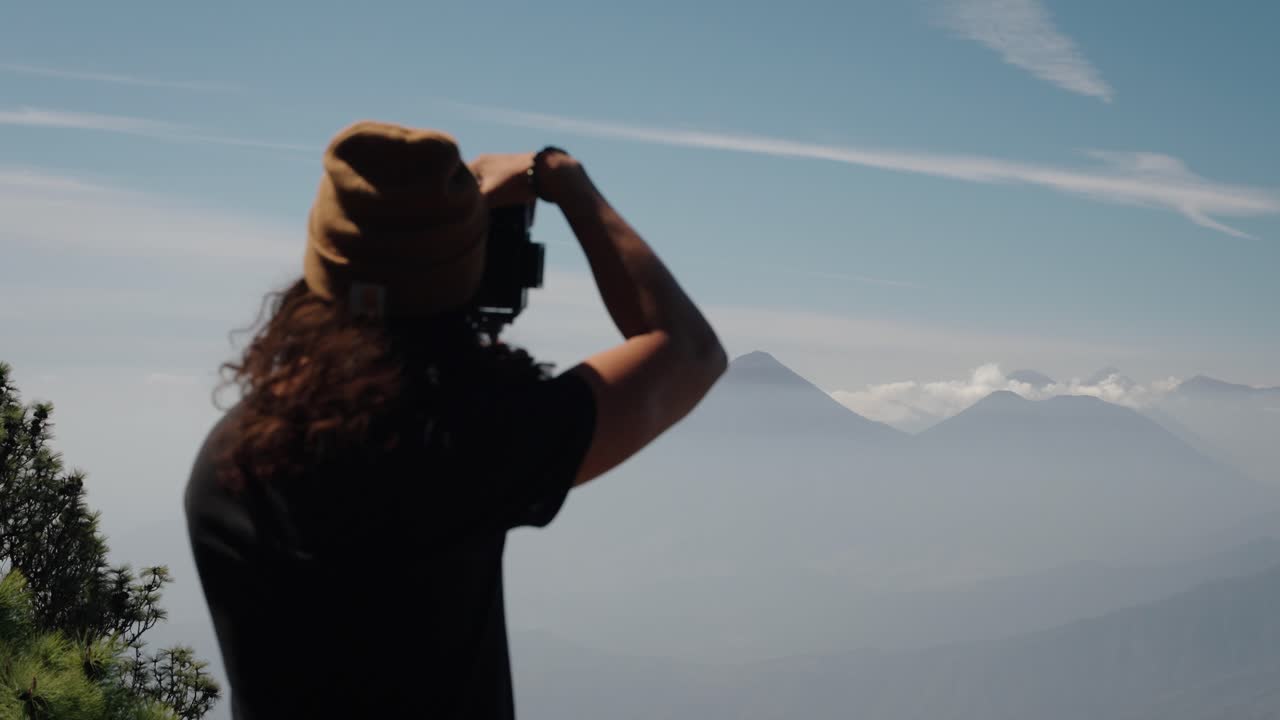 Traveler admiring Atitlan and Toliman volcanoes from Acatenango