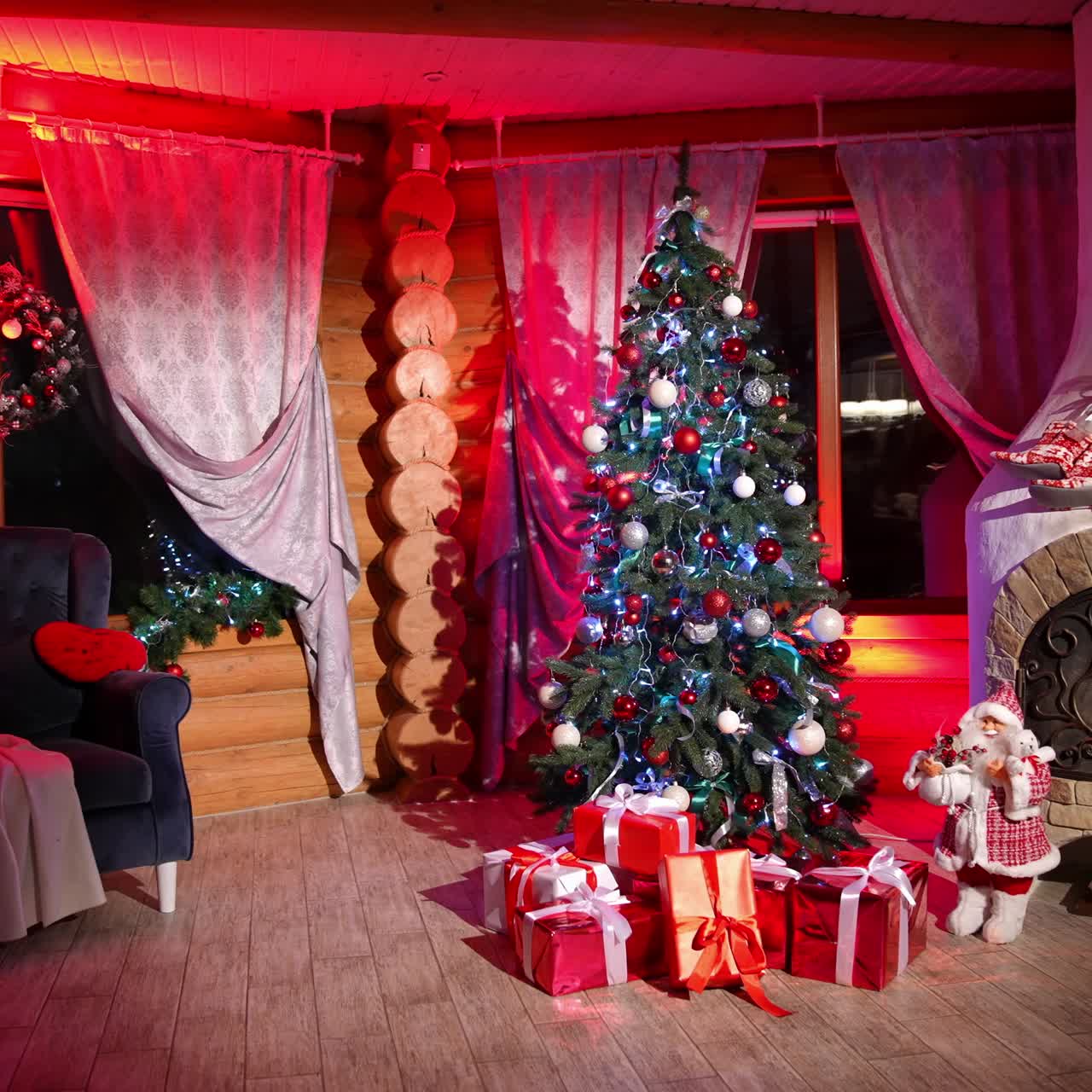 Cosy room with Christmas decorations. Empty living room is decorated with Christmas tree and presents near fireplace. Christmas Day at night festival coming soon