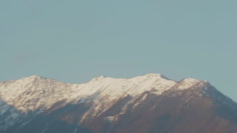 fast pan across snow capped alp mountain