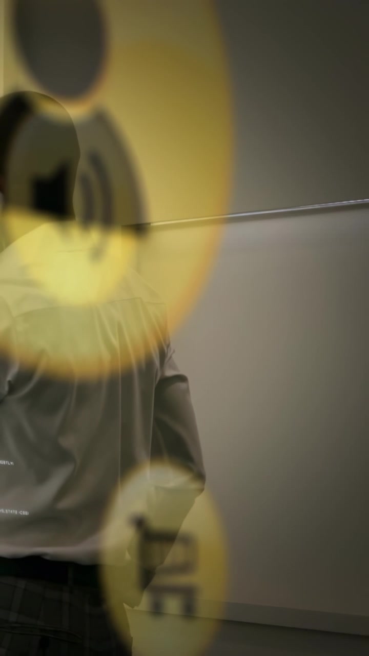 Vertical video: Man near wall shifting marketing icons entering left covering head showing sales