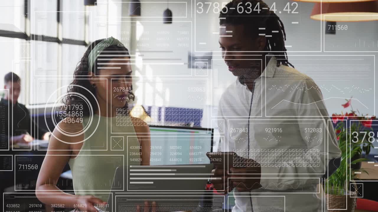 Animation of data processing over diverse male and female colleague talking and using laptop