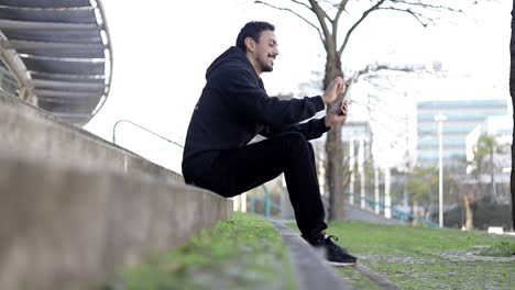 Un-Joven-Sonriente-Con-Tablet-Pc-En-La-Calle