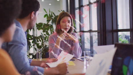 dna strand animation over diverse team discussing documents at office table
