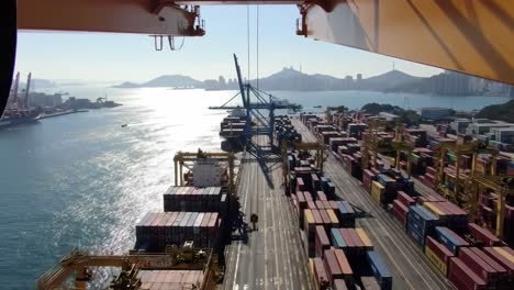 stunning aerial view of a busy shipping port capturing container stacking and loading operations amidst a beautiful maritime landscape