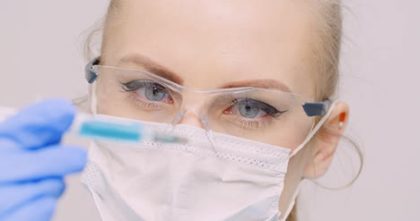 doctor holding syringe in hands