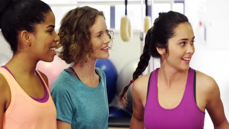 Beautiful-women-interacting-with-each-other-in-fitness-studio