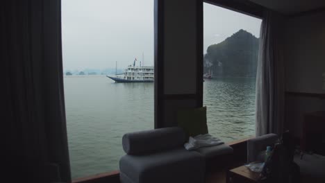 gimbal shot through the master suite on a tourist boat in ha long bay, vietnam, showing the bay and mountains outside