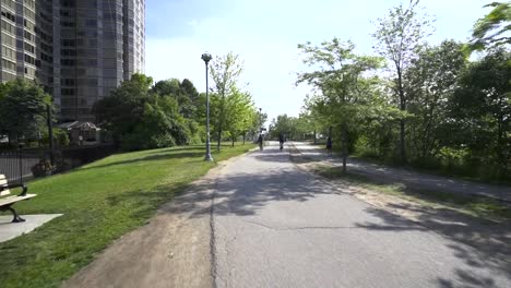 Cyclist-biking-on-a-path-in-sunny-downtown-Toronto-in-summer