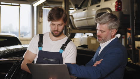 mechanic and manager discussing car repair