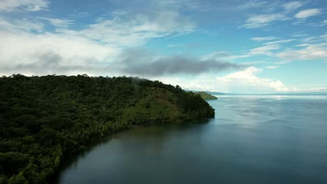 Aerial-view-of-Puerto-Jimenez-Costa-Rica,-blue-water-and-green-landscape