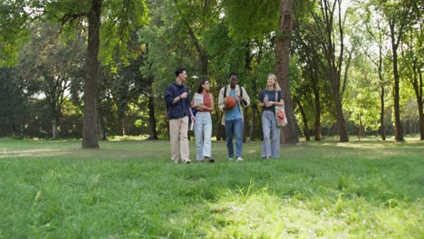 group of diverse students walking in a park