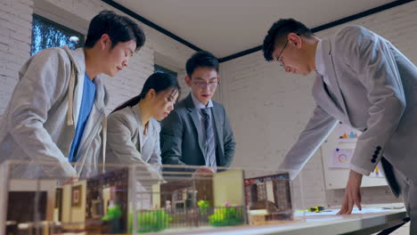 discussion with team of architectures and businessmen discussing and brainstorming on floor plan modification for real estate investment, housing development project