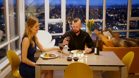 couple toasting glass of wine while having dinner 4k