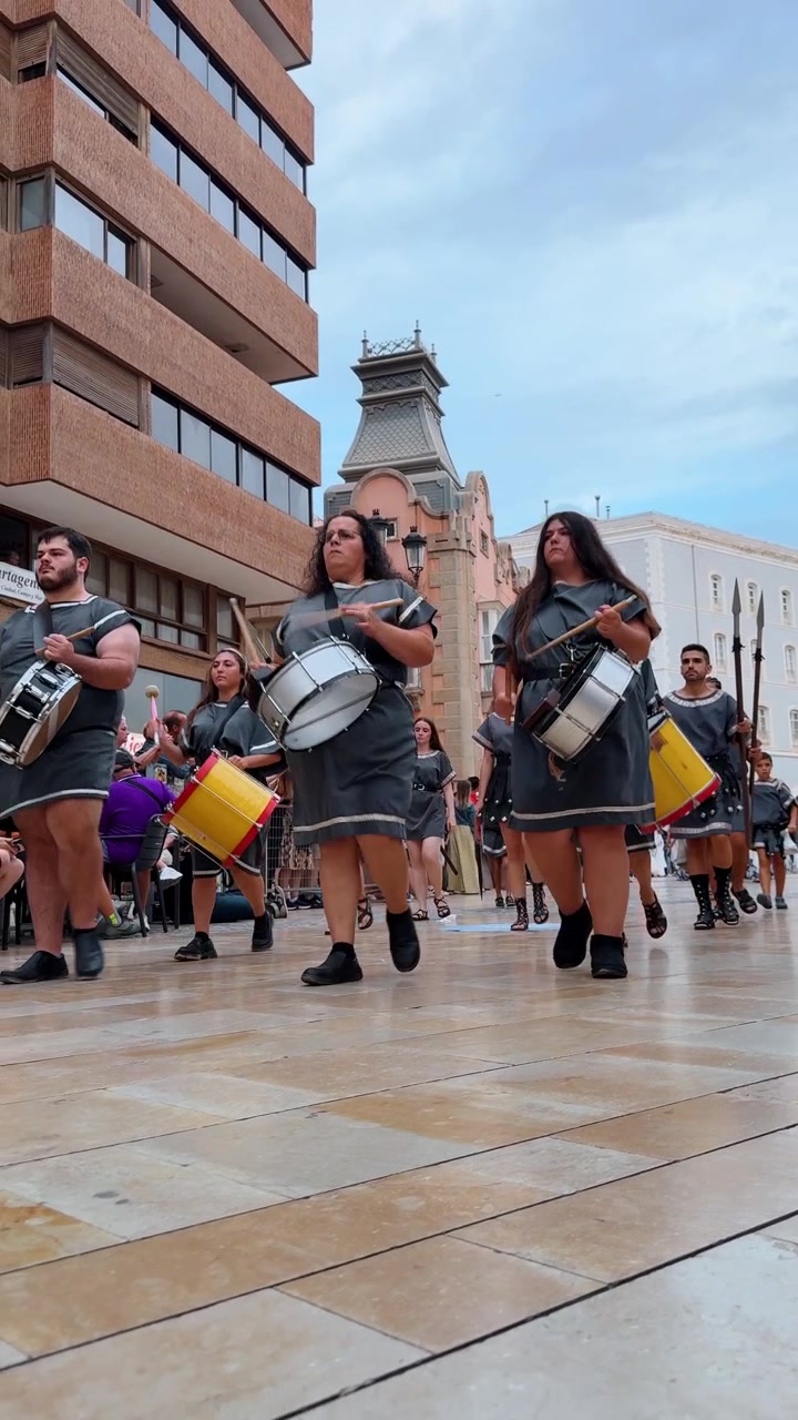 Alicante, Spain, 8 August 2025: Woman in ancient Roman soldier costume marching in parade.