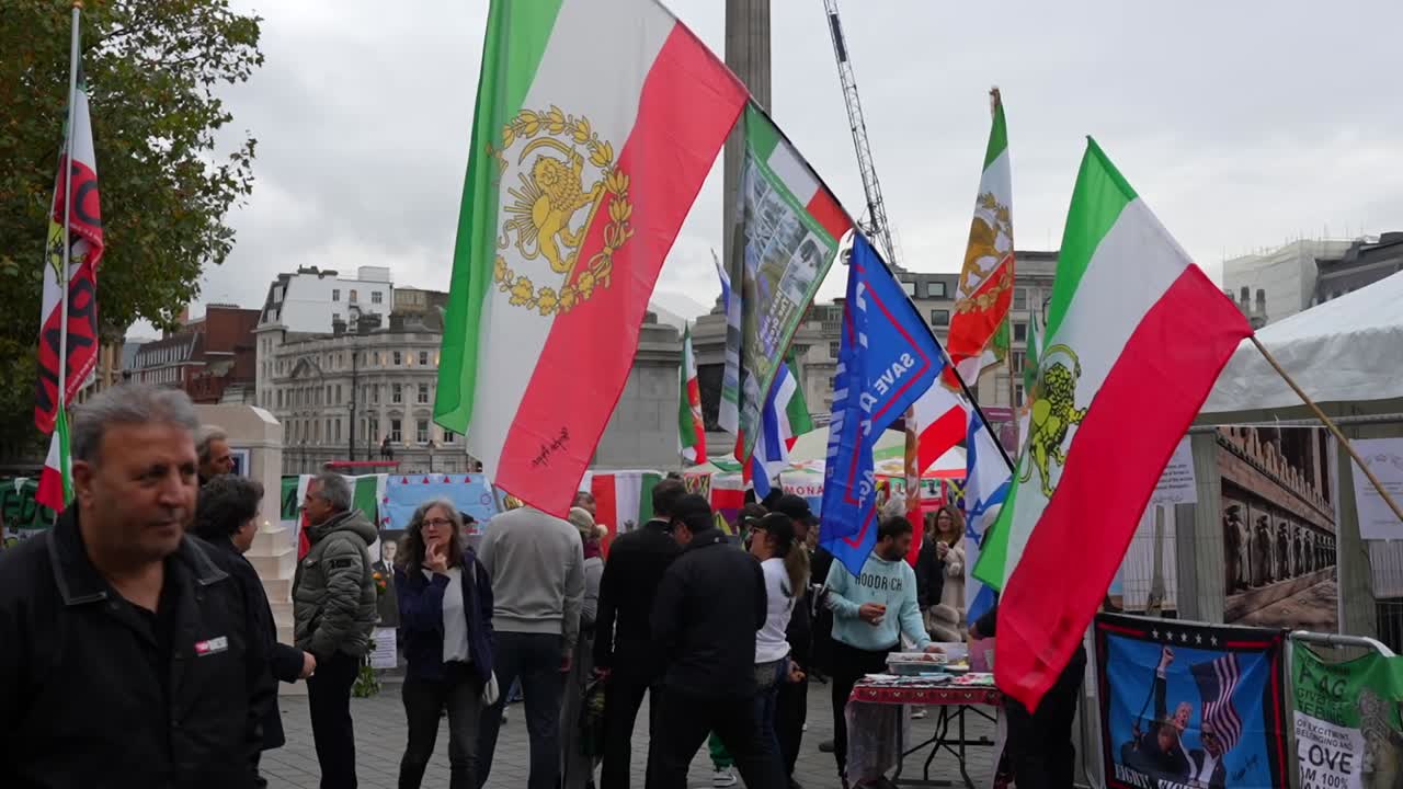 Protesters gather at London's Trafalgar Square waving Iranian flags in a call for monarchy restoration