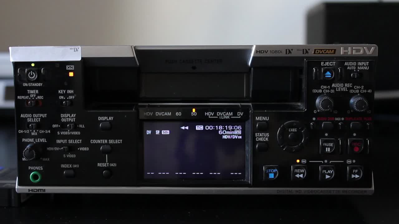 Hand Inserting and Playing Cassette in Professional HDV DVCAM Video Recorder