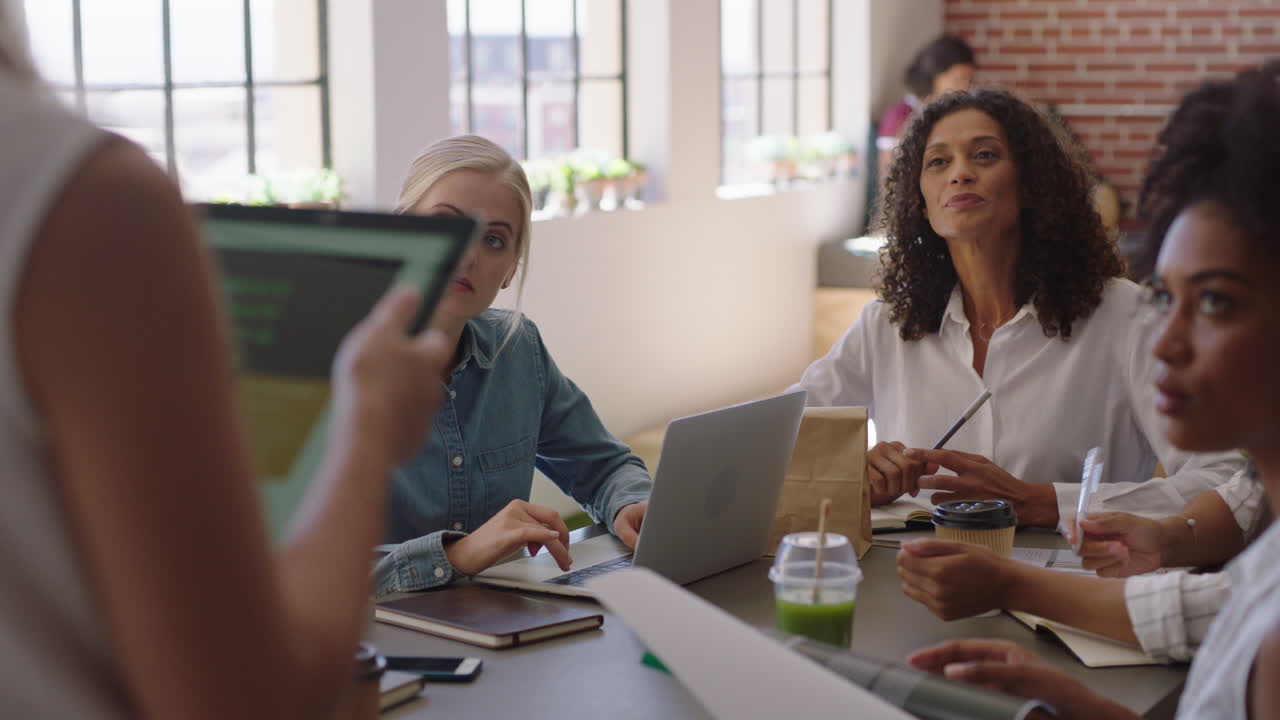mujeres de negocios multiétnicas que se reúnen, líderes de equipos de lluvia de ideas que comparten ideas creativas para un proyecto de inicio utilizando la tecnología de tabletas en la presentación de la oficina.