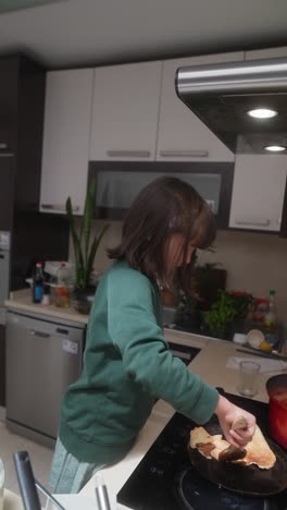 a girl cooking pancakes
