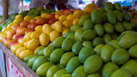 vibrant display of fresh mangoes at a market stall