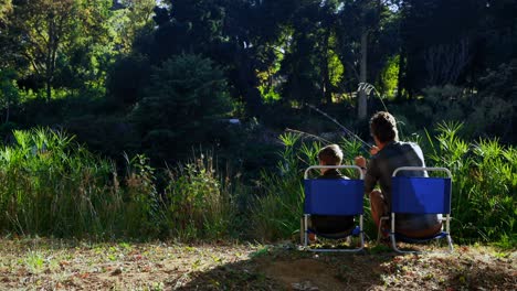 father and son fishing at countryside