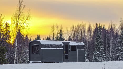 Modern-sauna-building-in-winter-forest,-time-lapse-view