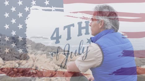 Animation-of-independence-day-text-over-senior-caucasian-man-sitting-on-rocks